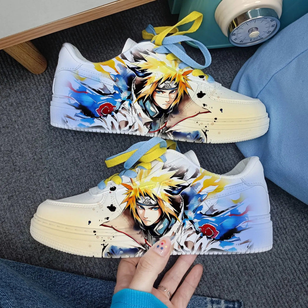 Close-up of white Naruto Minato low-top sneakers with yellow-cream toe and watercolour Minato print