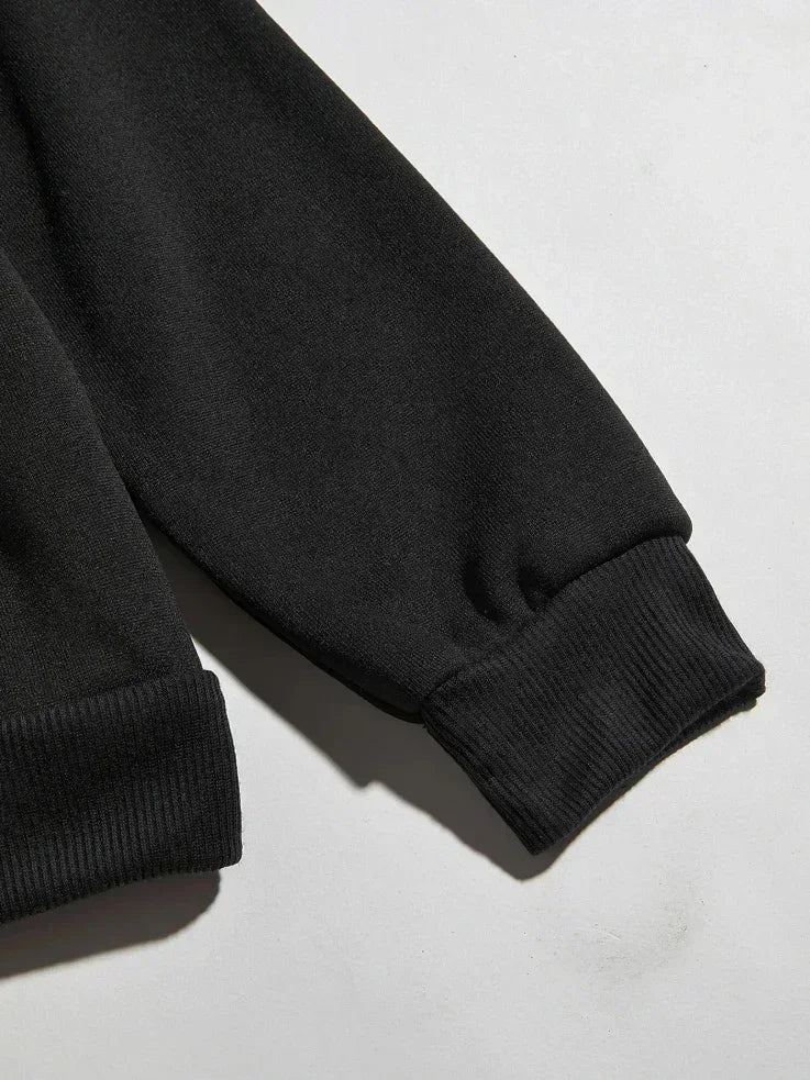 Close-up of the sleeve and ribbed hem on the black Solo Leveling No Limit hoodie