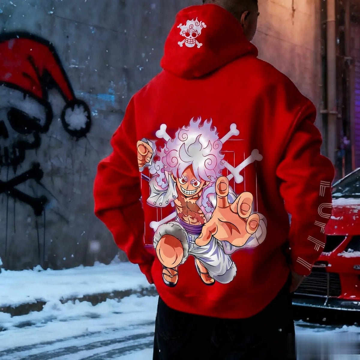 Back of red One Piece Luffy hoodie with Gear 5 Luffy and crossbones print and Luffy lettering on the sleeve