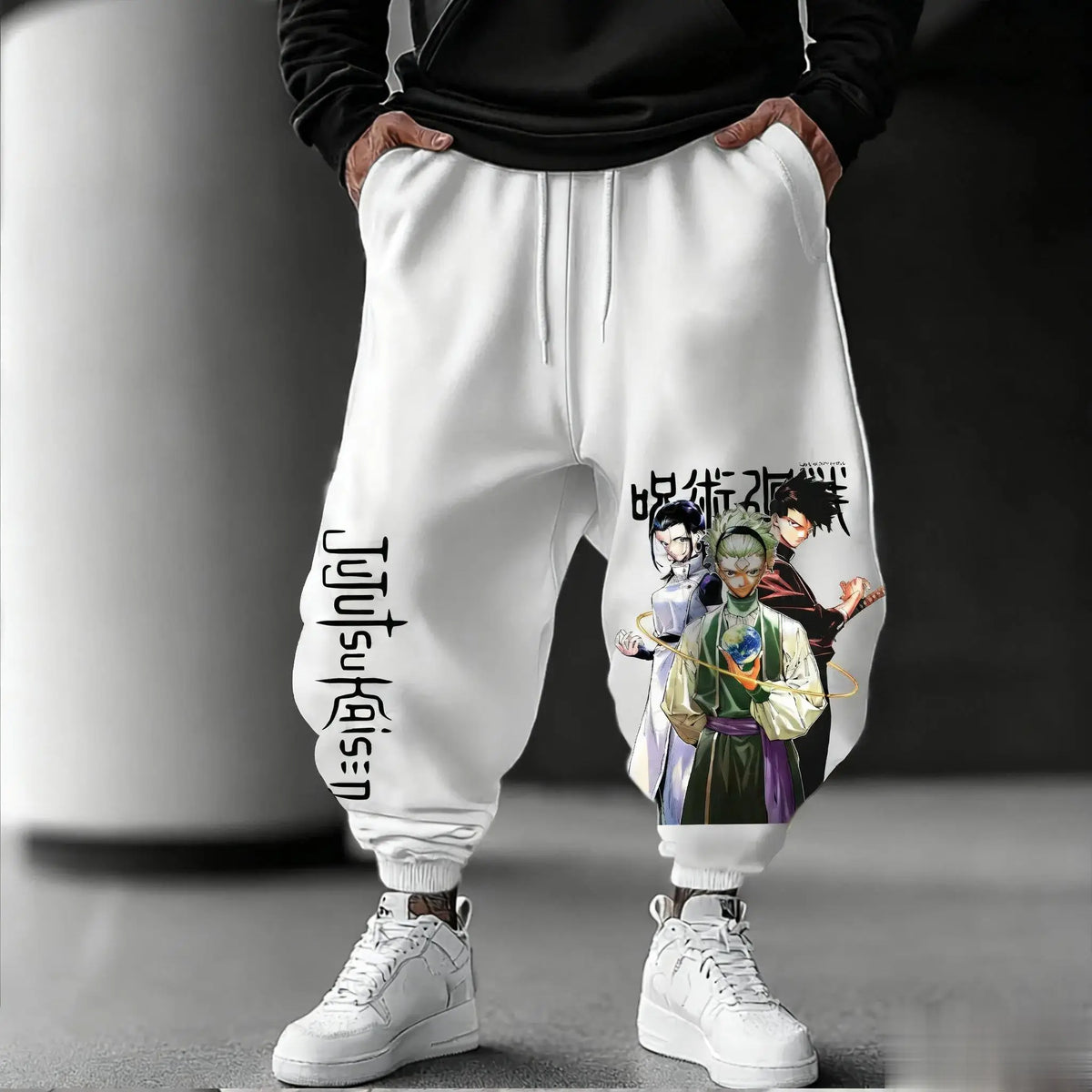 White Jujutsu Kaisen joggers with colour print of three characters and Jujutsu Kaisen lettering down the leg